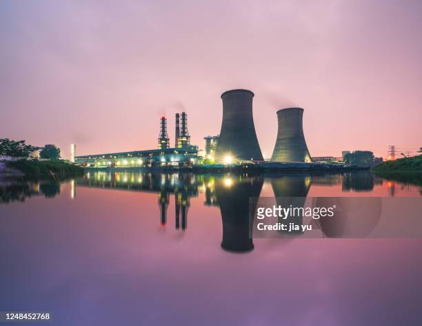 power plant by the river, night. wuxi city, jiangsu province. - nuclear power station stock pictures, royalty-free photos & images