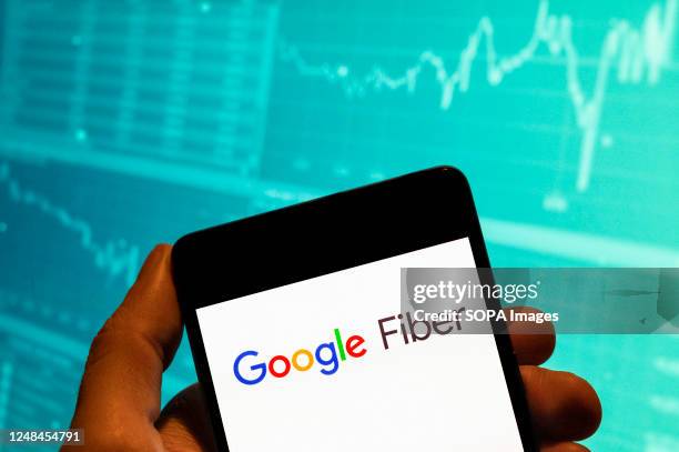 In this photo illustration, the American fast Internet service provider by Google, Google Fiber, logo is seen displayed on a smartphone with an...