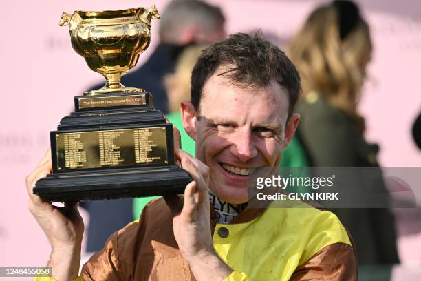 Jockey Paul Townend celebrates with the trophy after riding Galopin Des Champs to win the Cheltenham Gold Cup Chase race on the final day of the...