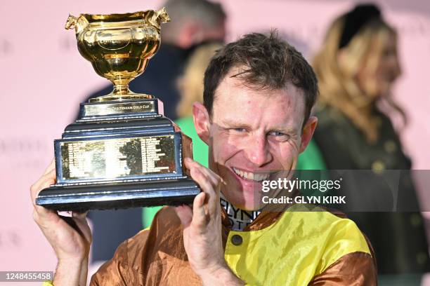 Jockey Paul Townend celebrates with the trophy after riding Galopin Des Champs to win the Cheltenham Gold Cup Chase race on the final day of the...