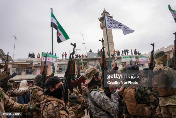 Syrians raise the flags of the revolution and chant in major demonstrations to celebrate the twelfth anniversary of the Syrian revolution against the...
