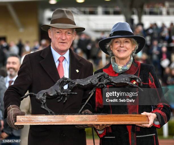 Gloucestershire , United Kingdom - 17 March 2023; Trainer Willie Mullins and his wife Jackie with the 'Leading Trainer Award' during day four of the...