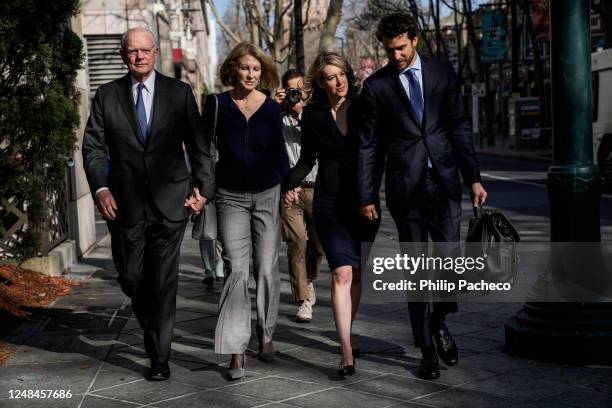 Former Theranos CEO Elizabeth Holmes , alongside her father Christian Holmes IV , mother Noel Holmes and boyfriend Billy Evans , makes her way to...