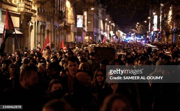 Protesters march during a demonstration in Lille, northern France, on March 17 the day after the French government pushed a pensions reform using the...