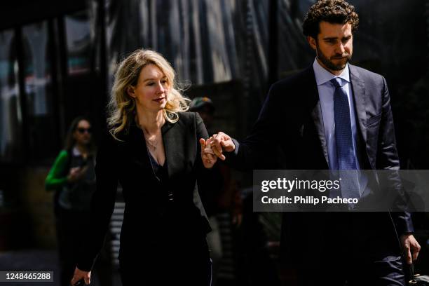 Former Theranos CEO Elizabeth Holmes alongside her boyfriend Billy Evans, walks back to her hotel following a hearing at the Robert E. Peckham U.S....