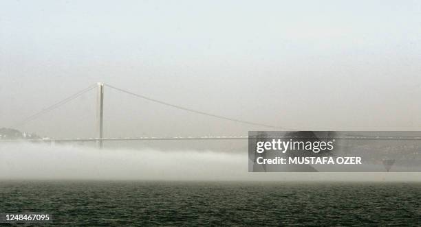 The Bosphorus Bridge is seen in the fog,17 March 2005 in Istanbul. Heavy fog has covered the Bosphorus and has affected international shipping for...