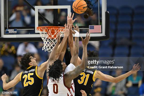 Osun Osunniyi and Tre King of the Iowa State Cyclones compete for a rebound with Guillermo Diaz Graham and Jorge Diaz Graham of the Pittsburgh...