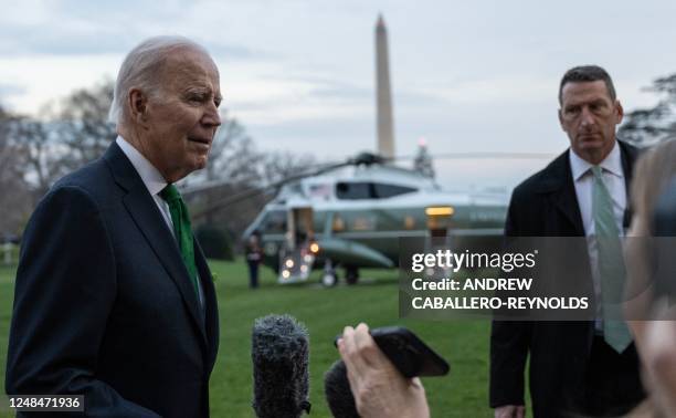 President Joe Biden talks to the media before boarding Marine One from the South Lawn of the White House in Washington, DC, on March 17, 2023. -...