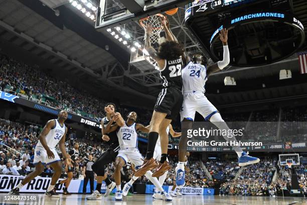 Devin Carter of the Providence Friars competes for the ball with Chris Livingston of the Kentucky Wildcats during the first round of the 2023 NCAA...