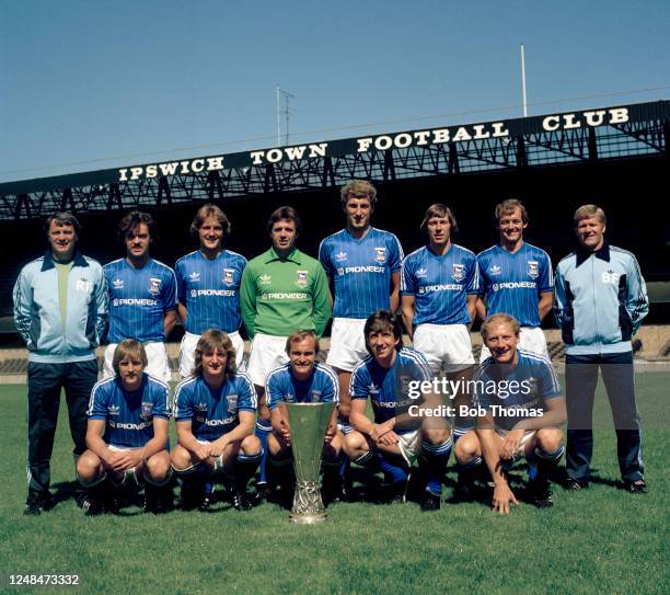 The Ipswich Town XI pose for a group photo with the trophy after winning the UEFA Cup, at Portman Road on July 30, 1981 in Ipswich, England. Back row...