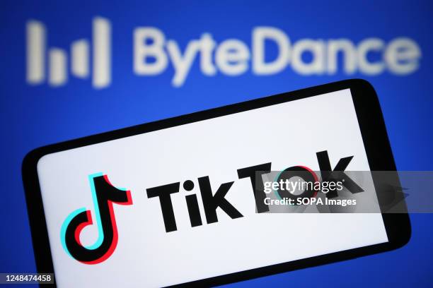 In this photo illustration, a TikTok logo is seen on a smartphone and ByteDance logo in the background.