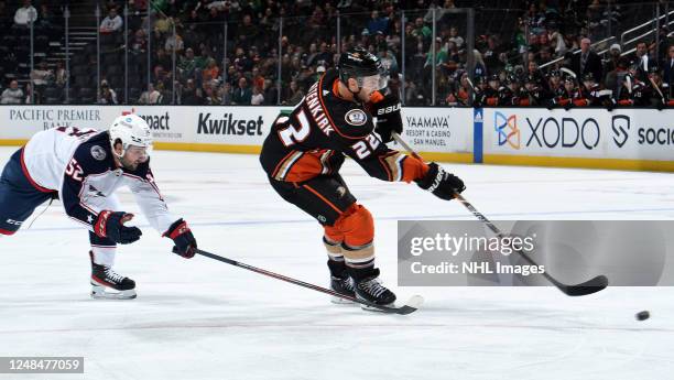 Kevin Shattenkirk of the Anaheim Ducks takes a shot with pressure from Emil Bemstrom of the Columbus Blue Jackets during the game at Honda Center on...