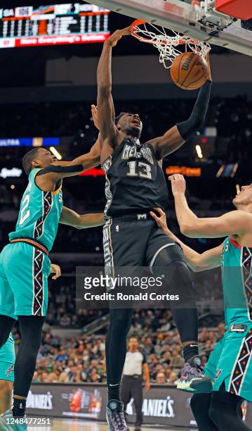 Jaren Jackson of the Memphis Grizzlies dunks past San Antonio Spurs Malaki Branham in the second half at AT&T Center on March 17, 2023 in San...