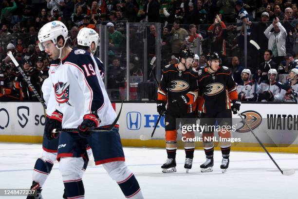 Scott Harrington and Ryan Strome of the Anaheim Ducks celebrate a first period goal against Liam Foudy and the Columbus Blue Jackets at Honda Center...