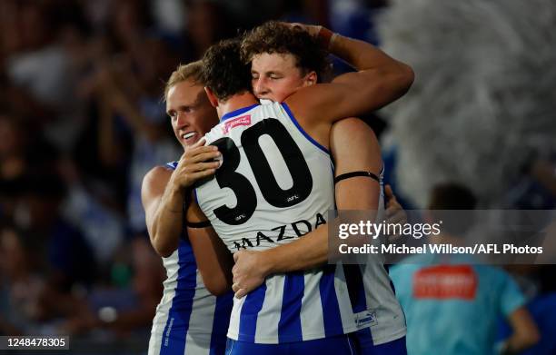 Jaidyn Stephenson, Charlie Comben and Nick Larkey of the Kangaroos celebrate during the 2023 AFL Round 01 match between the North Melbourne Kangaroos...