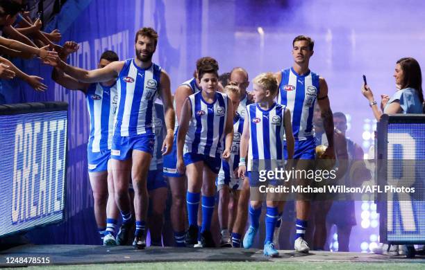 Luke McDonald and Jy Simpkin of the Kangaroos lead their team up the race during the 2023 AFL Round 01 match between the North Melbourne Kangaroos...