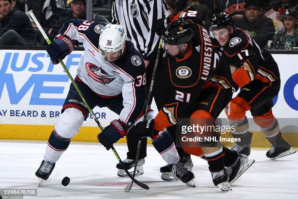 Boone Jenner of the Columbus Blue Jackets battles in a face-off against Isac Lundestrom of the Anaheim Ducks during the game at Honda Center on March...