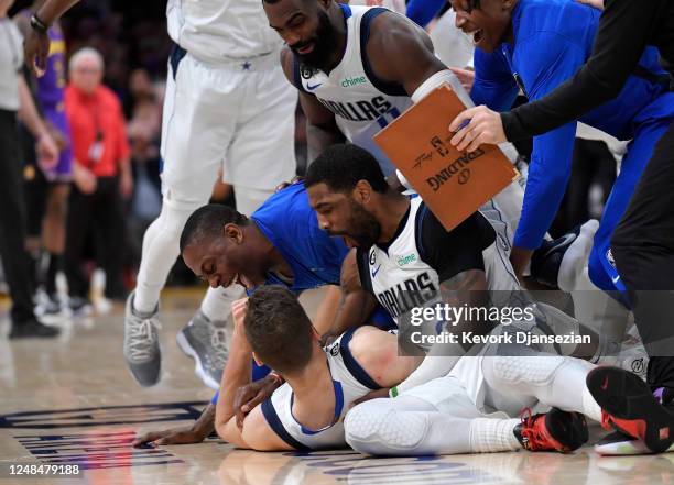 Kyrie Irving of the Dallas Mavericks celebrates with Maxi Kleber after he scored the game winning winning there-point basket against Anthony Davis of...