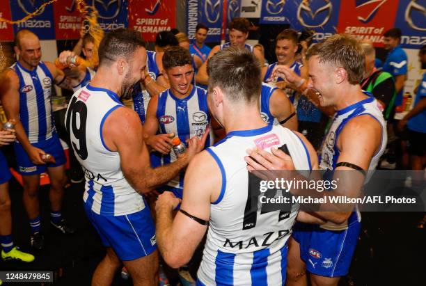 North players celebrate during the 2023 AFL Round 01 match between the North Melbourne Kangaroos and the West Coast Eagles at Marvel Stadium on March...