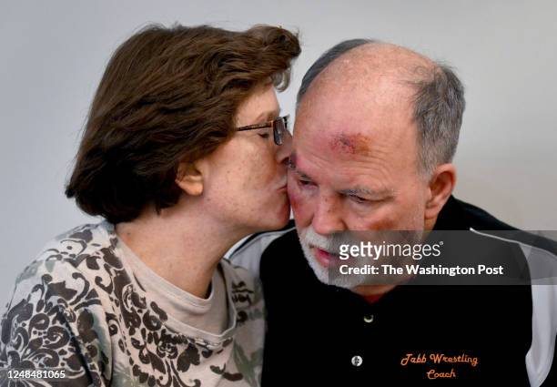Beth Roper plants a kiss on the cheek of her husband Doug Roper at a memory care facility in Poquoson, Virginia on March 11, 2023. Doug Roper is...