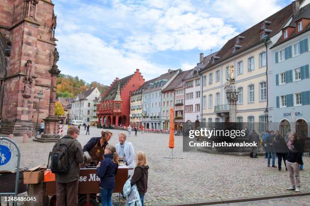 autumn afternoon scene in freiburg around old cathedral - freiburg skyline stock pictures, royalty-free photos & images