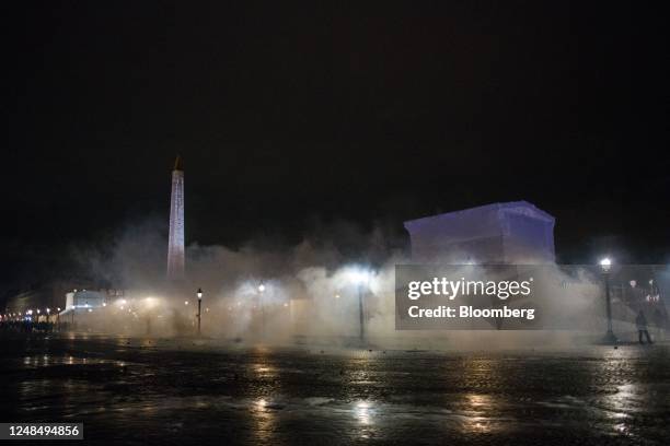 Riot police release tear gas during a protest against pension reform at Place de la Concorde in Paris, France, on Friday, March 17, 2023. Thousands...