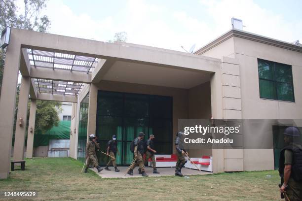 Pakistani police gather on former Pakistans prime minister Imran Khan residence during a police raid on Khan's residence in Lahore on March 18 after...