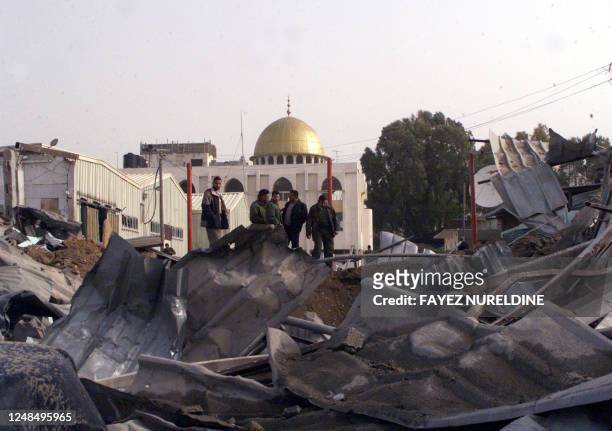Palestinian policemen inspect 11 February 2002 the damaged Ansar base of Palestinian leader Yasser Arafat's elite Force 17 in Gaza City, which was...