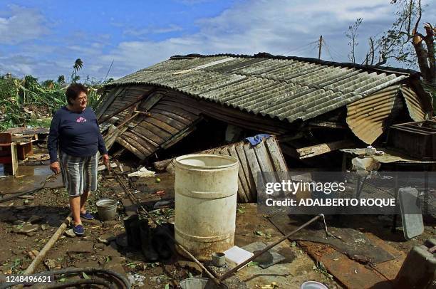 Woman sees the damage caused to her home due to the recent hurricane in Jaguey Grande, Cuba 05 November 2001. Una mujer contempla los danos...