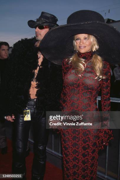 American rock drummer Tommy Lee and his wife, Canadian actress Pamela Anderson attend the 24th Annual American Music Awards, held at the Shrine...