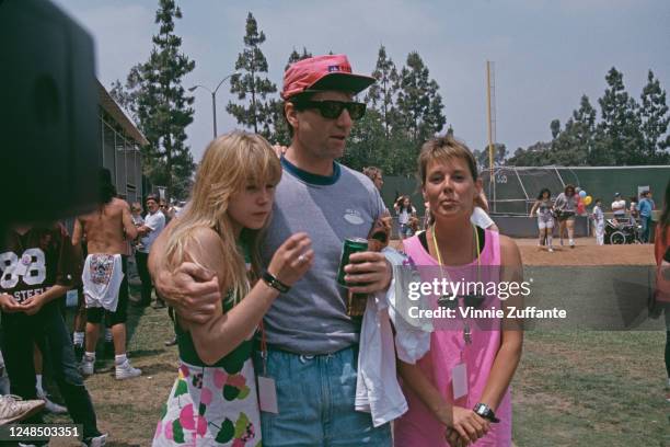 American actress Christina Applegate wearing a mini dress with coloured umbrella motifs, American actor and comedian Ed O'Neill, and American actress...