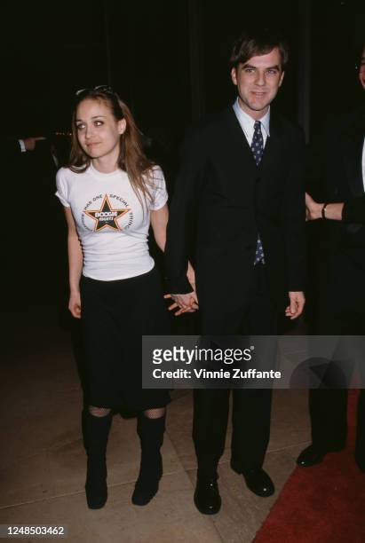 American singer-songwriter Fiona Apple, wearing a 'Boogie Nights' t-shirt, and American film director Paul Thomas Anderson attend the 50th Annual...