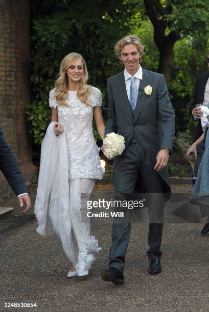 Poppy Delevingne and her husband James Cook are seen at Poppy Delevingne wedding on May 14, 2014 in London, England.