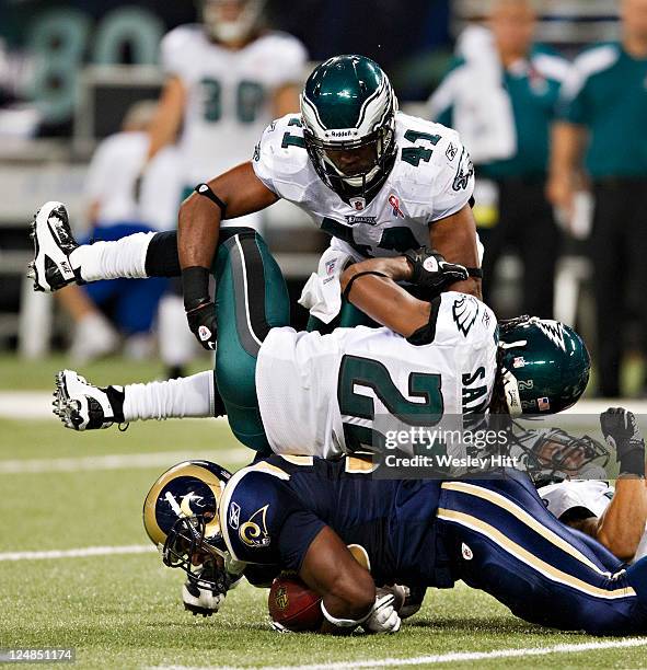 Asante Samuel and Jarrad Page of the Philadelphia Eagles tackles Carnell Williams of the St. Louis Rams at the Edward Jones Dome on September 11,...