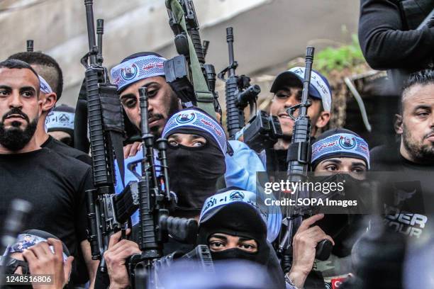 Masked Palestinian gunmen from the Al-Aqsa Martyrs Brigades of the Fatah movement led by President Mahmoud Abbas seen carrying their weapons during...