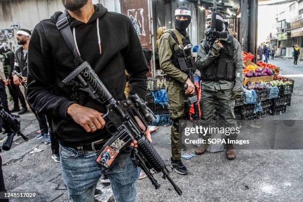 Masked Palestinian gunmen from the Al-Aqsa Martyrs Brigades of the Fatah movement led by President Mahmoud Abbas seen carrying their weapons during...