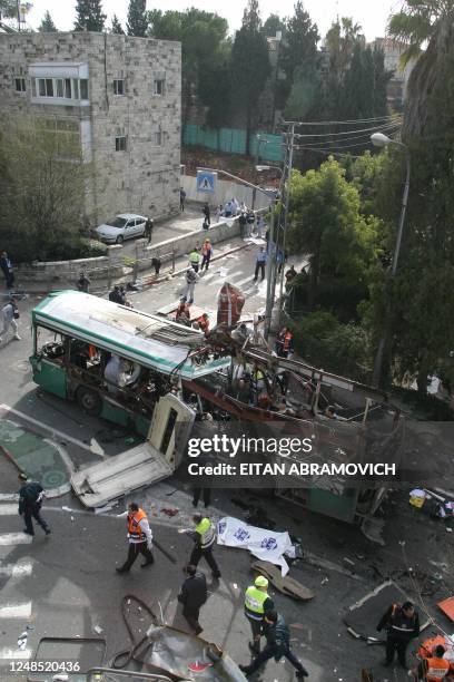 Israeli security personnel secures the area following a Palestinian suicie attack on a bus in Jerusalem 29 January 2004. At least ten people were...