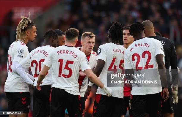 Southampton's English midfielder James Ward-Prowse speks to teammates during the English Premier League football match between Southampton and...