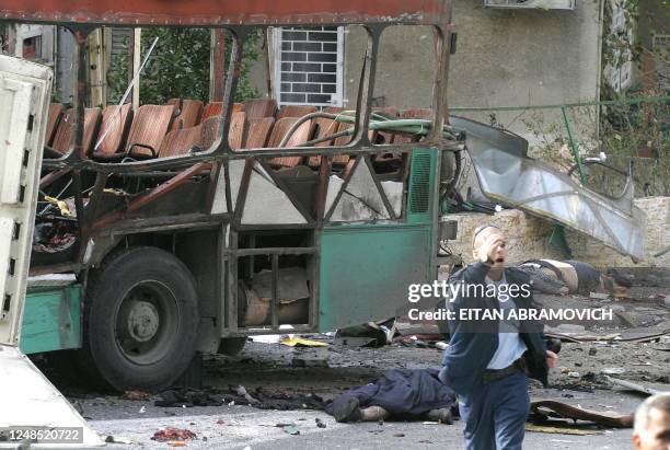 Israeli security personnel secures the area following a Palestinian suicide attack on a bus in Jerusalem 29 January 2004. At least ten people were...