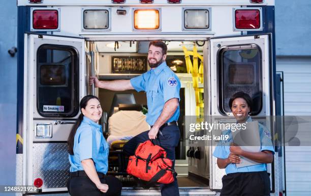 paramedics at the rear doors of an ambulance - flash back stock pictures, royalty-free photos & images