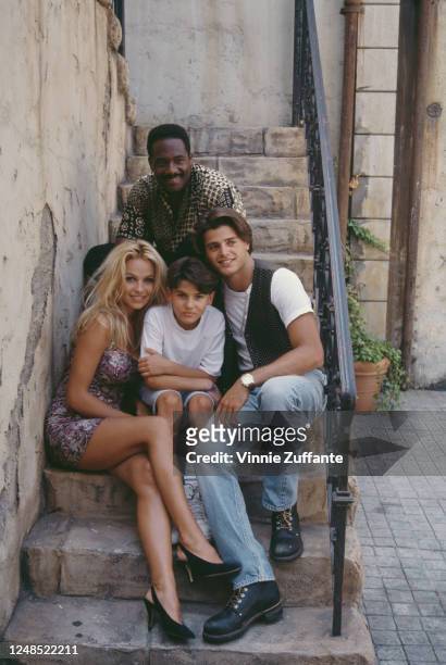 American actor Gregory Alan Williams, Canadian actress Pamela Anderson, wearing a floral print mini dress, American actor Jeremy Jackson, and French...
