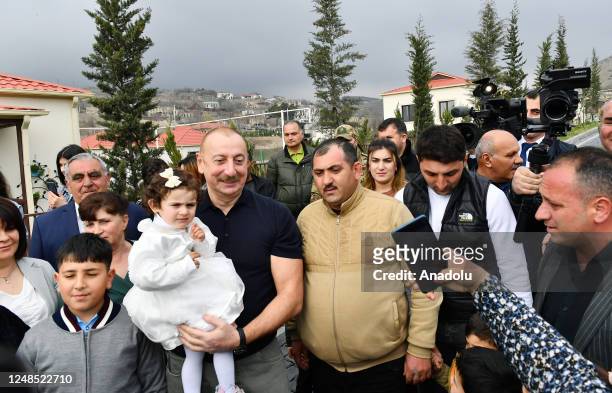 Azerbaijani President Ilham Aliyev, his wife Mihriban Aliyeva and their daughter Arzu Aliyeva meet with the people live in the village after lighting...