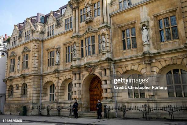 Police officers stand guard outside Oriel College and the Rhodes statue on it's facade prior to a protest called by the Rhodes Must Fall campaign on...