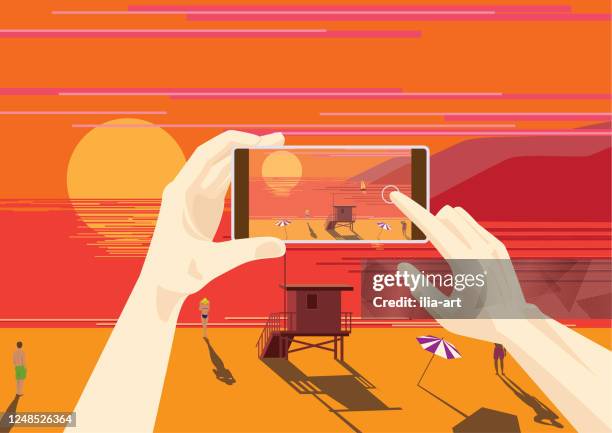 someone is photographing a sunset on the west coast. - beach la stock illustrations
