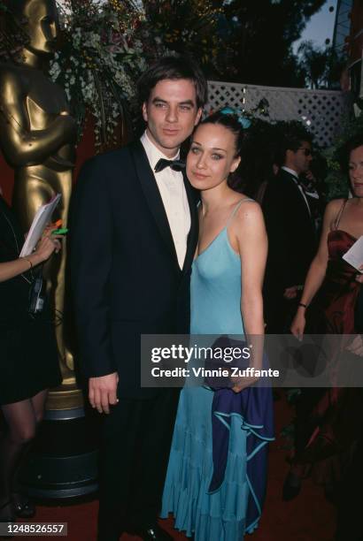 American film director Paul Thomas Anderson and American singer-songwriter Fiona Apple attend the 70th Annual Academy Awards, held at the Shrine...