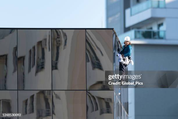 window washer of skyscrapers - abseiling stock pictures, royalty-free photos & images