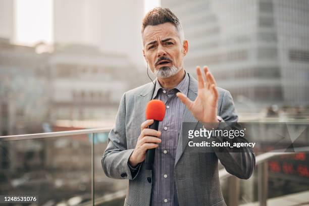 handsome male reporter in live broadcasting relays today's news - journalism stock pictures, royalty-free photos & images