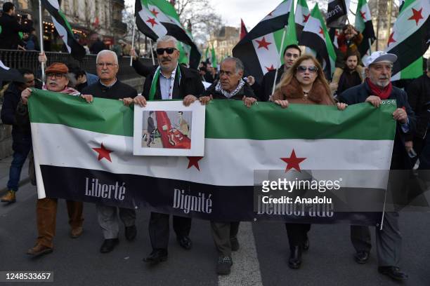 Demonstrators march during a rally to commemorate the 12th anniversary of the Syrian Civil War in Paris, on March 18, 2023.