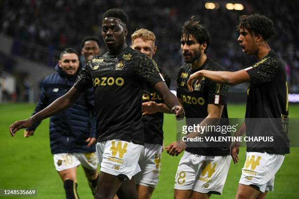 Lille's Franco-Guinean forward Mohamed Bayo celebrates with teammates after scoring his team's second goal during the French L1 football match...