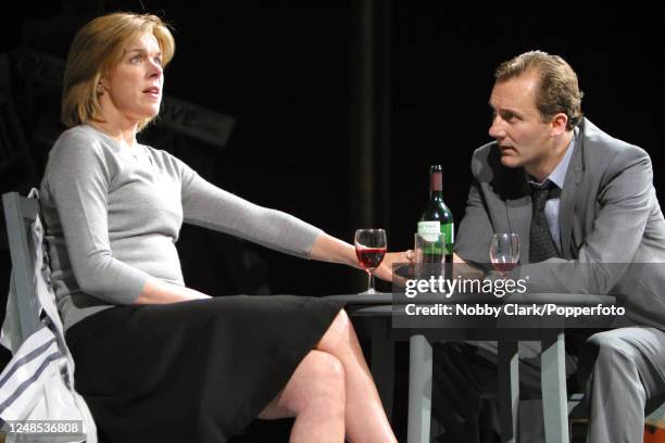 British actors Janie Dee and Aden Gillett performing in a dress rehearsal for Harold Pinter's "Betrayal", directed by Sir Peter Hall at the Theatre...